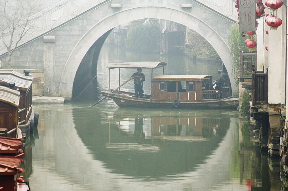 Traditional stone arched bridge and river boat in Shantang water town, Suzhou, Jiangsu Province, China, Asia