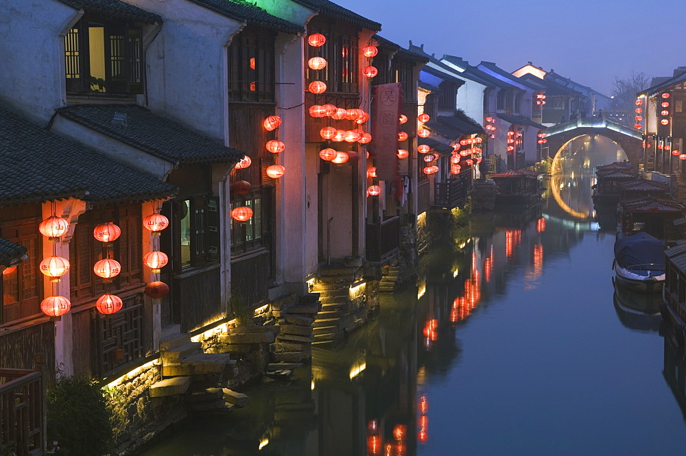 Traditional old riverside houses illuminated at night in Shantang water town, Suzhou, Jiangsu Province, China, Asia