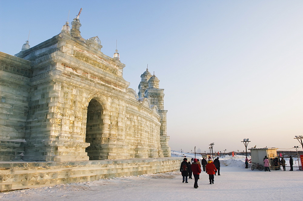 Tourists walking past the snow and Ice Sculptures at the Ice Lantern Festival, Harbin, Heilongjiang Province, Northeast China, China, Asia