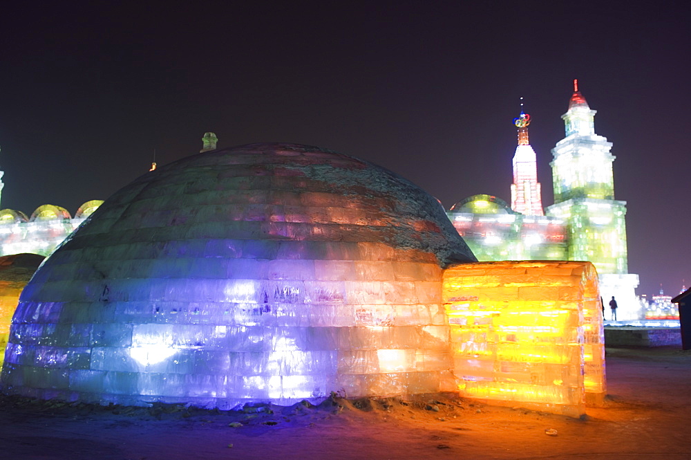 An igloo ice sculpture illuminated at night at the Ice Lantern Festival, Harbin, Heilongjiang Province, Northeast China, China, Asia