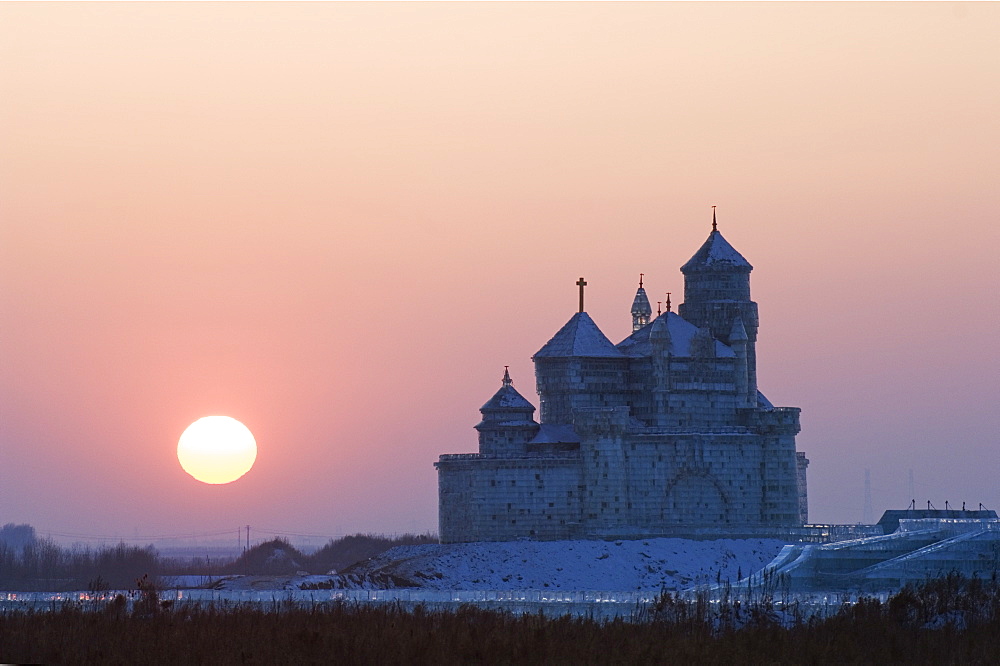 Sunset over an ice sculpture of a Russian orthodox church replica at the Ice Lantern Festival, Harbin, Heilongjiang Province, Northeast China, China, Asia