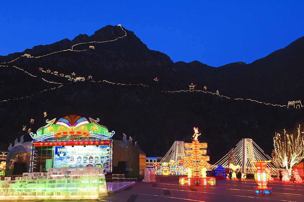 A display of night time illuminations and copy of the Great Wall of China at Longqing Gorge Ice sculpture festival, Beijing, China, Asia