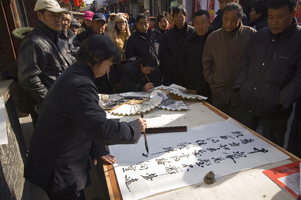 Calligraphy artist in a local neighbourhood hutong, Beijing, China, Asia