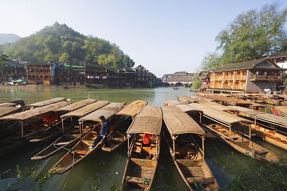 Boats tied up on a river in the old town of Fenghuang, Hunan Province, China, Asia