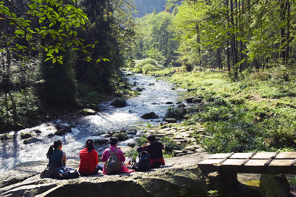 Hikers taking a break near a river, Zhangjiajie Forest Park, Wulingyuan Scenic Area, UNESCO World Heritage Site, Hunan Province, China, Asia