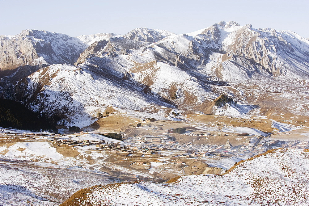 Snow capped mountains surrounding Langmusi town, on borders of Gansu and Sichuan Provinces, China, Asia