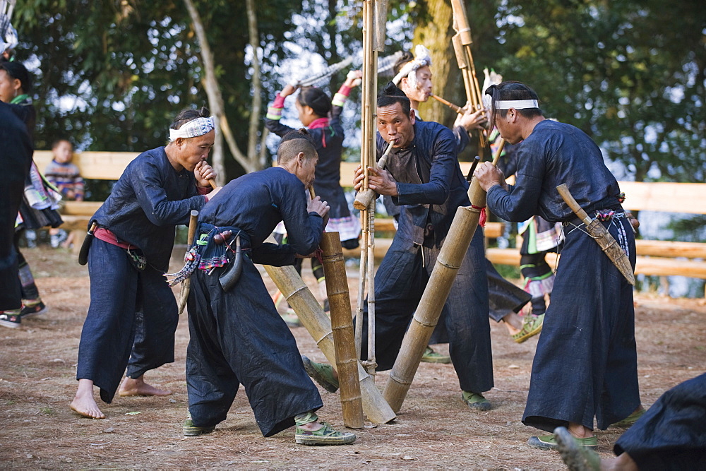 Miao ethnic minority group playing traditional musical bamboo instruments at Basha, Guizhou Province, China, Asia