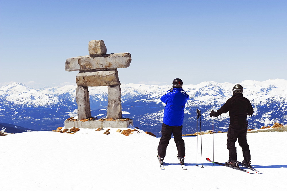 Skiers photographing an Inukshuk statue, Whistler mountain resort, 2010 Winter Olympics venue, British Columbia, Canada, North America