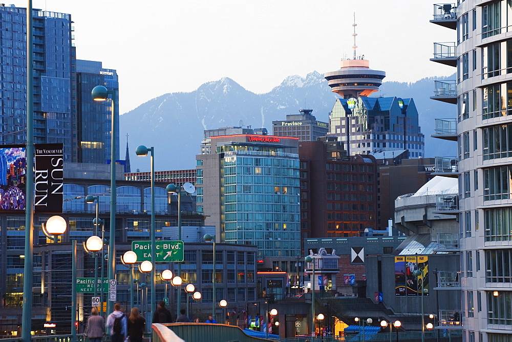 Snowy mountains behind downtown buildings and Harbour Centre Tower, Vancouver, British Columbia, Canada, North America