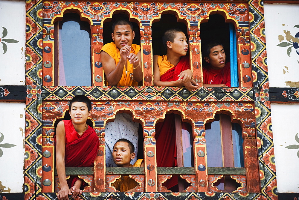 Young monks at a window, Chimi Lhakhang dating from 1499, Temple of the Divine Madman Lama Drukpa Kunley, Punakha, Bhutan, Asia