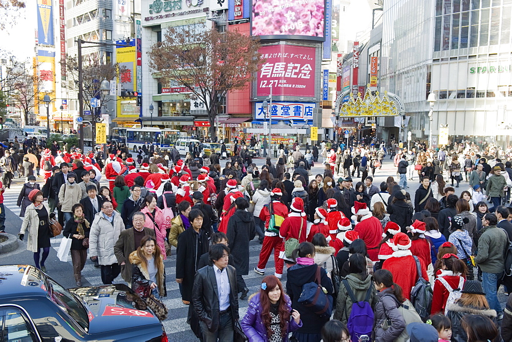 Christmas Santas walking across Shibuya crossing, Shibuya ward, Tokyo, Japan, Asia