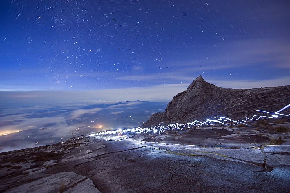 Stars and torch lights illuminating hiking trail, Kinabalu National Park (4095m), Sabah, Borneo, Malaysia, Asia