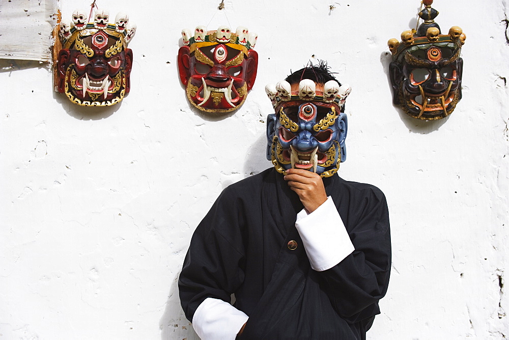 Man displaying traditional masks, Thimphu, Bhutan, Asia