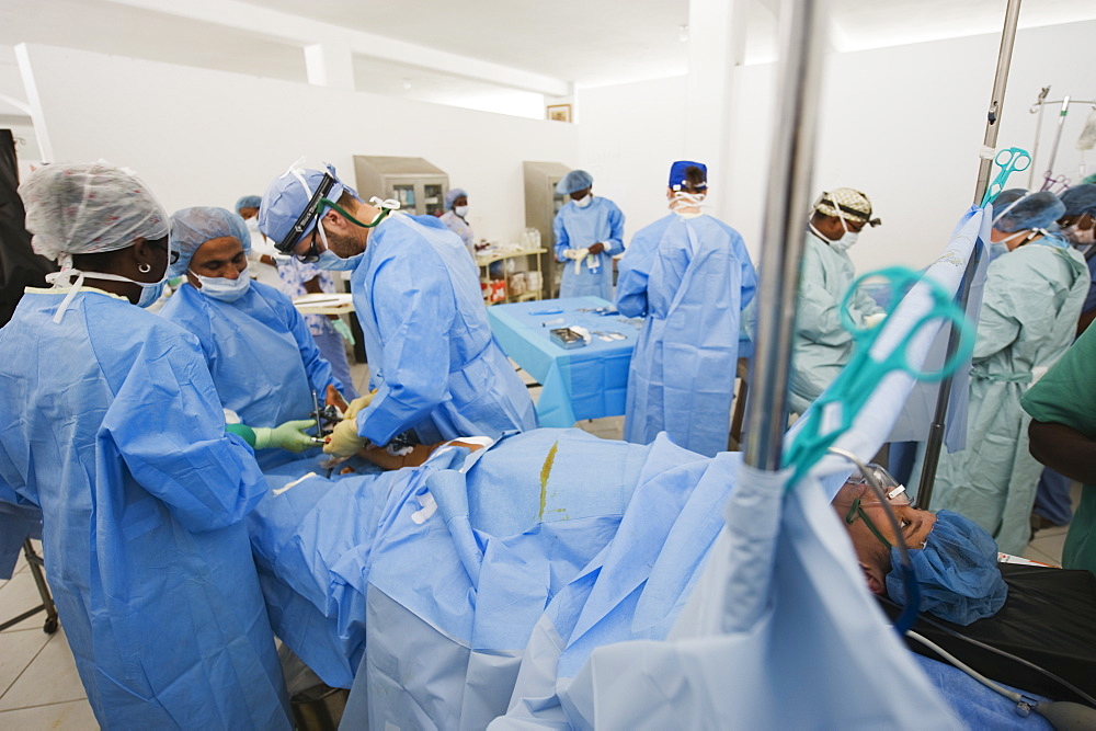 American doctor performing surgery, leg fracture patient, January 2010 earthquake, General Hospital, Port au Prince, Haiti, West Indies, Caribbean, Central America