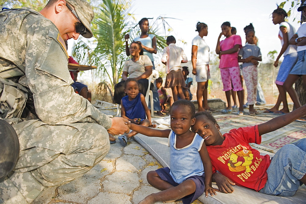 US Army soldier at an orphanage in Port au Prince after the 2010 earthquake, Port au Prince, Haiti, West Indies, Caribbean, Central America