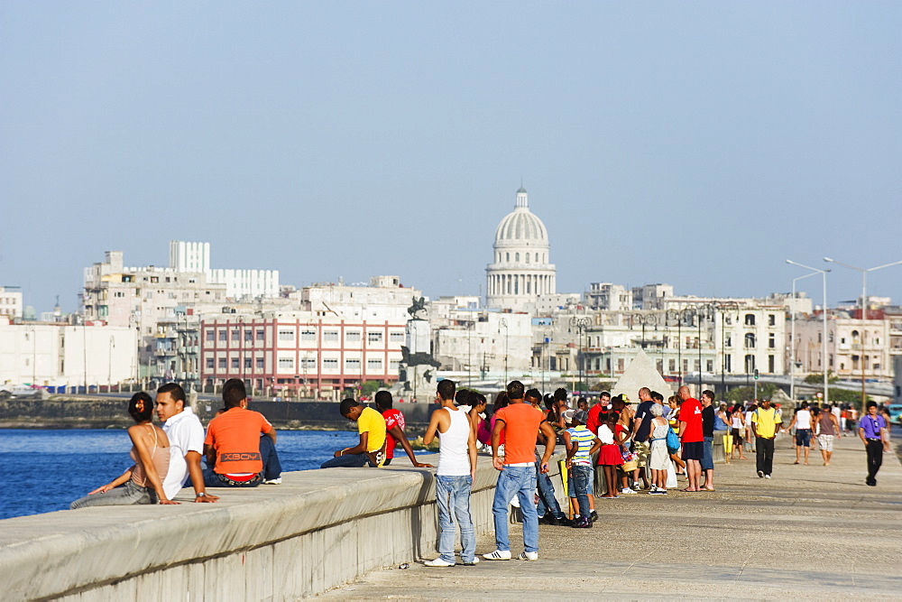 People walking on The Malecon, Capitolio and city skyline, Havana, Cuba, West Indies, Caribbean, Central America