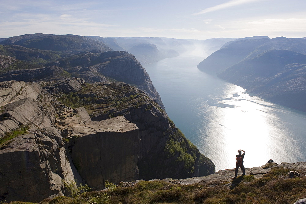 Man photographing the fjord, Preikestolen (Pulpit Rock), Lysefjord, Norway, Scandinavia, Europe