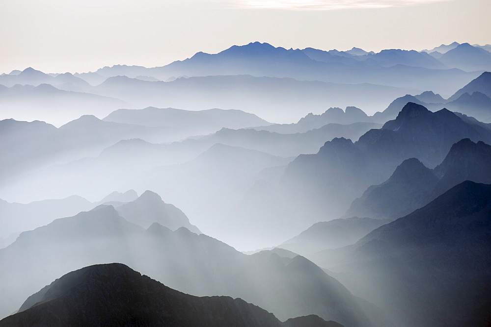 Mountains silhouetted at sunrise, view from Pico de Aneto, at 3404m the highest peak in the Pyrenees, Spain, Europe