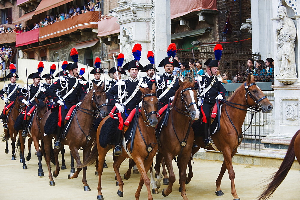 Horses and guards parading at El Palio horse race festival, Piazza del Campo, Siena, Tuscany, Italy, Europe