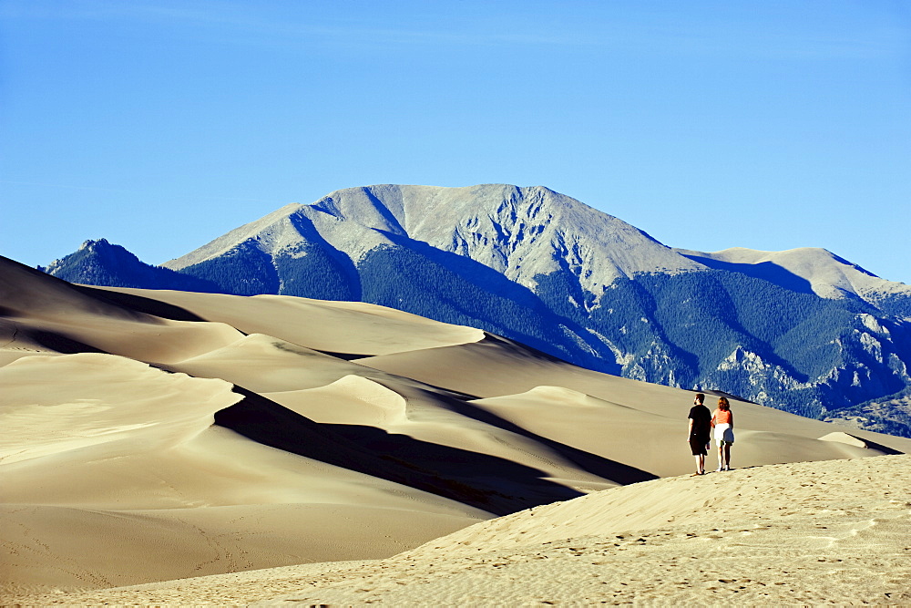 Couple walking in Great Sand Dunes National Park, Colorado, United States of America, North America