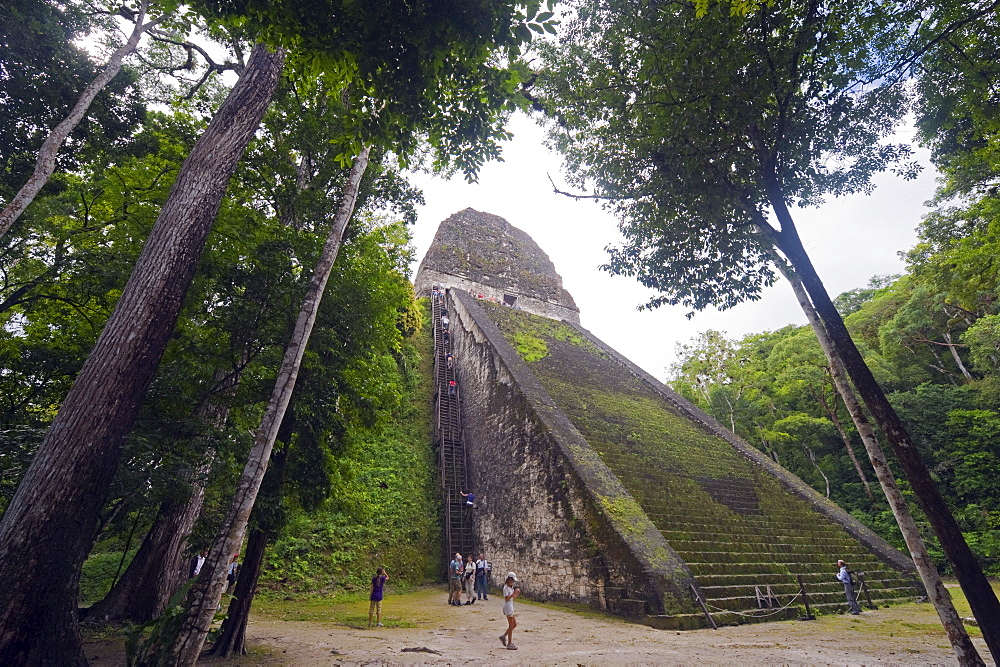 Tourists climbing a pyramid in the forest, Mayan ruins, Tikal, UNESCO World Heritage Site, Guatemala, Central America