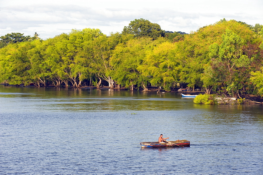 Man rowing a boat on Ometepe Island, Lake Nicaragua, Nicaragua, Central America