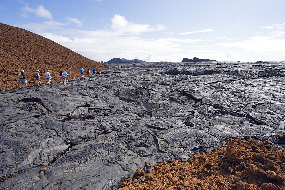 Tourists walking on lava flow on Isla Santiago, Sullivan Bay, Galapagos Islands, UNESCO World Heritage Site, Ecuador, South America