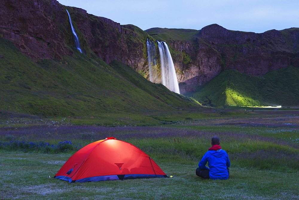 Seljalandsfoss waterfall lit up at night, Southern Region, Iceland, Polar Regions