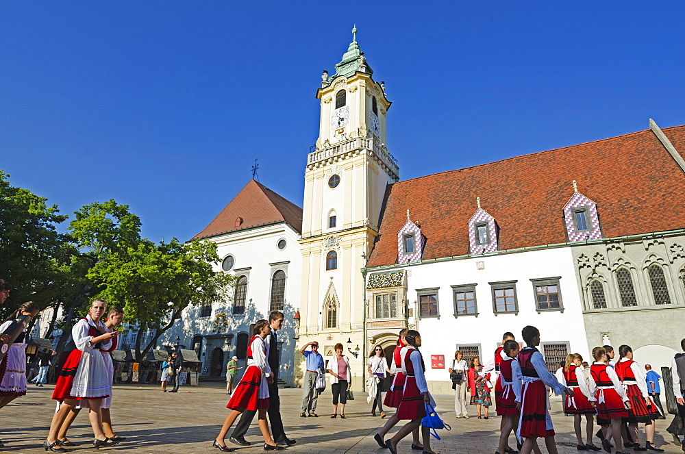 Children in traditional costume in the main square, Old Town Hall Municipal Museum dating from 1421, Bratislava, Slovakia, Europe