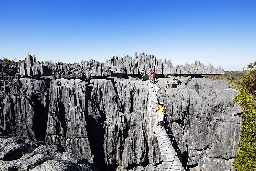 Tourist crossing a rope bride, Grand Tsingy, Tsingy du Bemaraha National Park, UNESCO World Heritage Site, western area, Madagascar, Africa