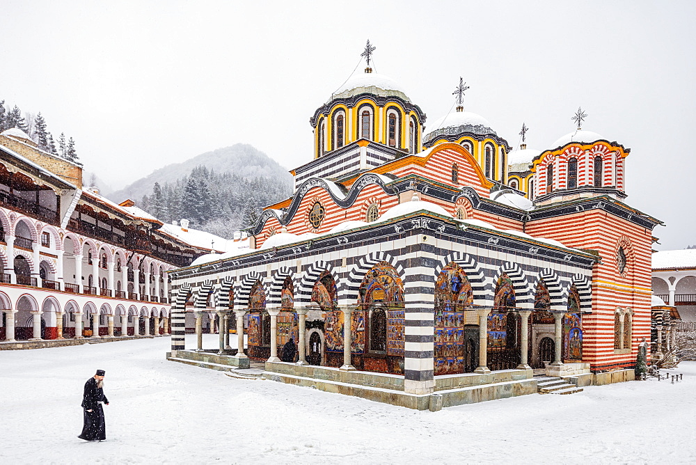 A priest at the Church of the Nativity of the Virgin Mother at Rila Monastery, UNESCO World Heritage Site, Bulgaria, Europe