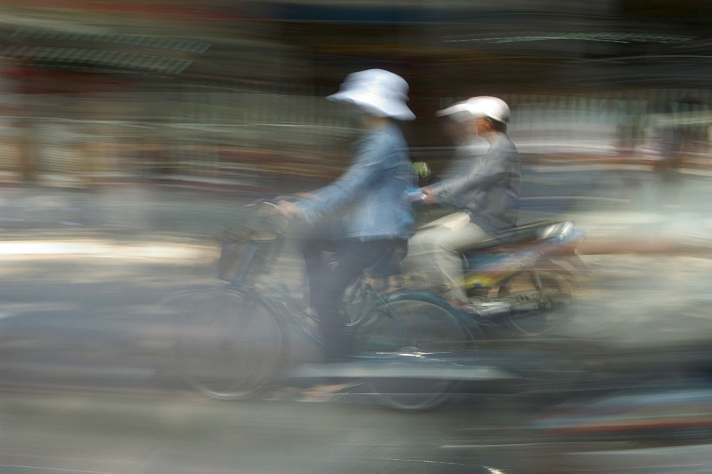 Motor bike and cyclist, Ho Chi Minh City (Saigon), Vietnam, Southeast Asia, Asia