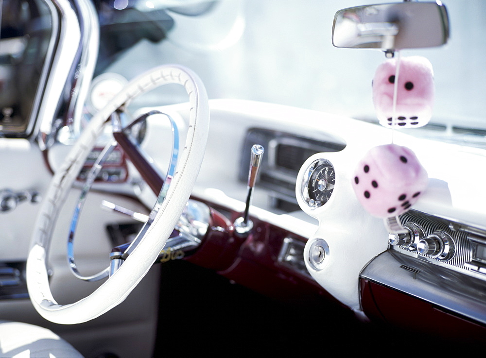 Close-up of steering wheel and interior of a pink Cadillac car