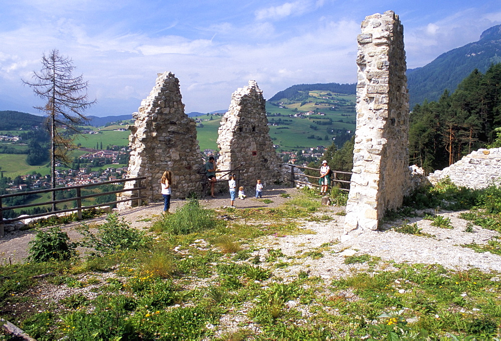 Visitors at Salegg (Salego) ruins and Siusi village, Sciliar National Park, Dolomites, Alto Adige, Italy, Europe