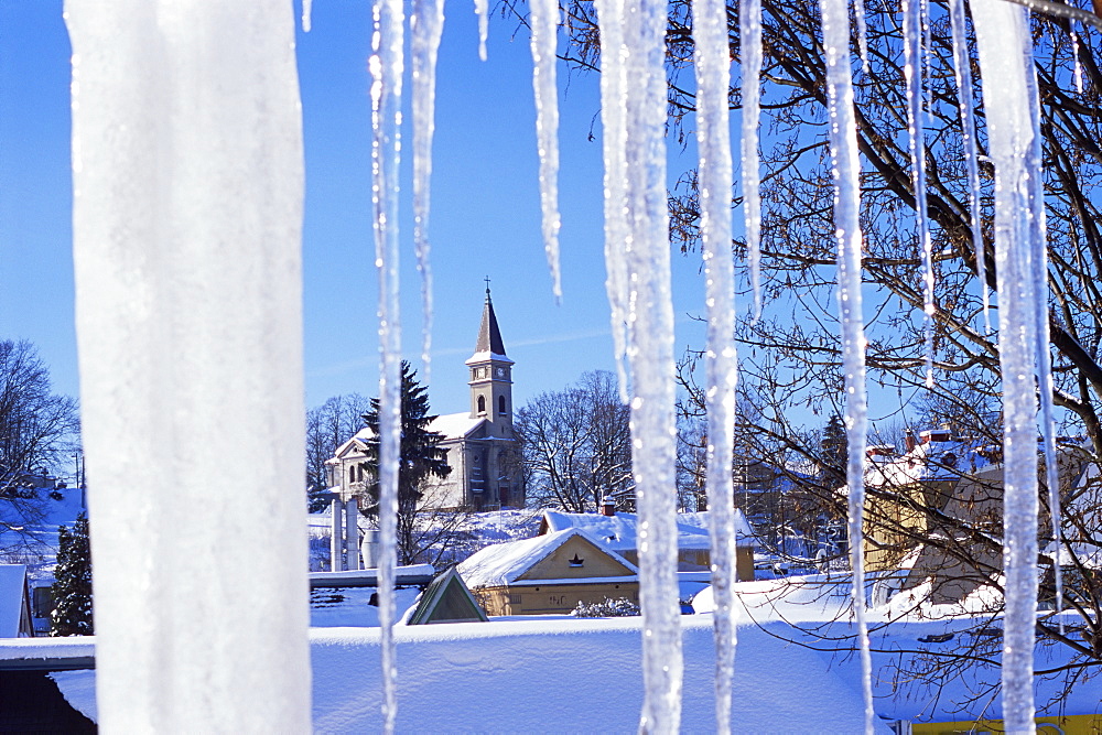 Catholic church in village of Luceny nad Nisou, Jizerske mountains, seen through icicles, Luceny nad Nisou, Liberecko, Czech Republic, Europe