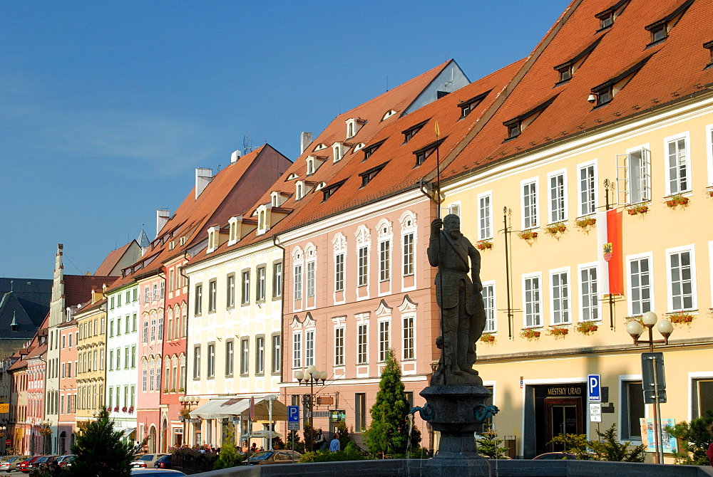 Silhouette of statue against row of Baroque houses on main Kral Jiri z Podebrad Square, town of Cheb, Karlovarsky Region, West Bohemia, Czech Republic, Europe