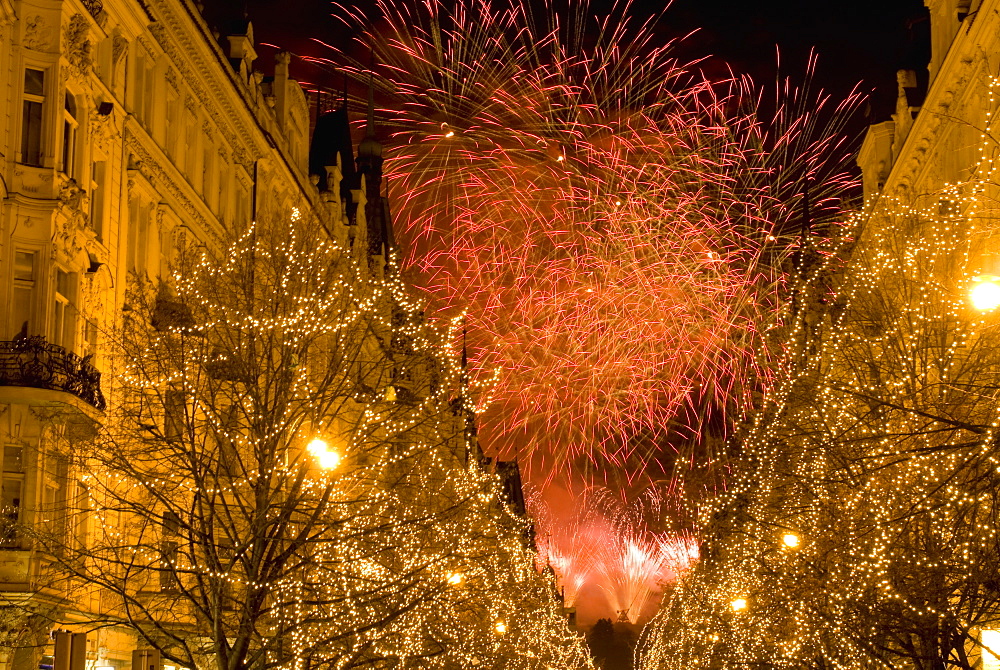 Christmas lights on trees and 19th century houses along Parizska Street and New Years Day fireworks, Stare Mesto (Old Town), UNESCO World Heritage Site, Prague, Czech Republic, Europe