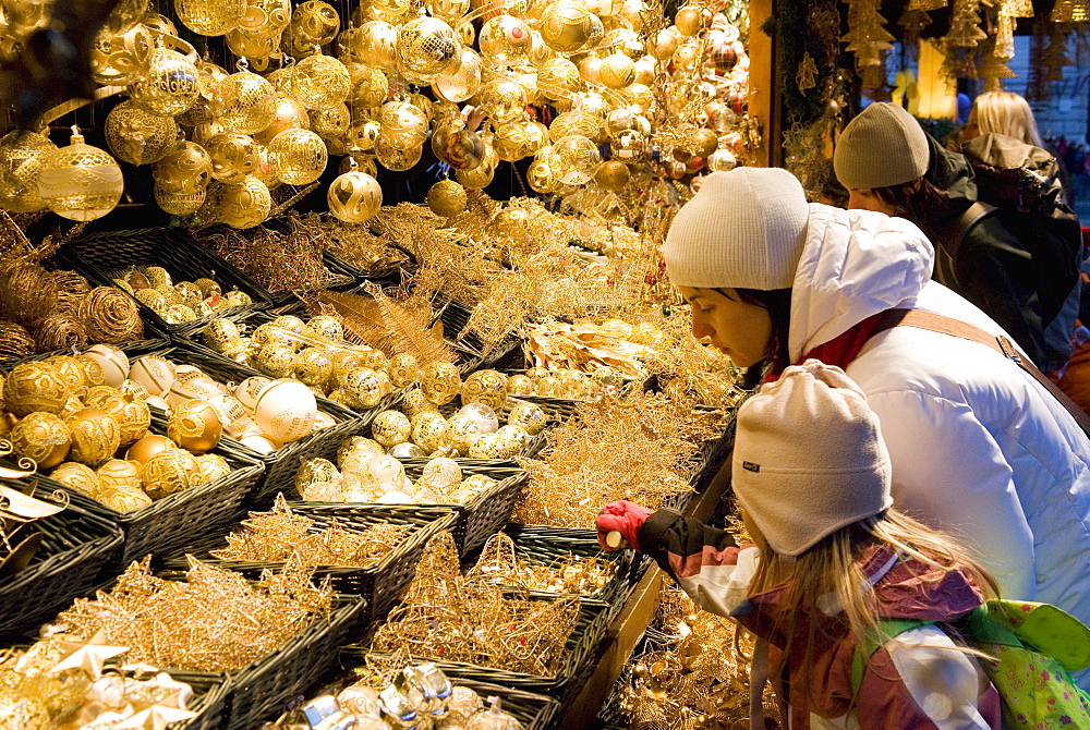 Girl and woman looking at Christmas decorations at stall, Christkindlmarkt (Christmas Market) at Rathausplatz, Innere Stadt, Vienna, Austria, Europe