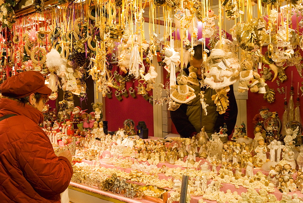 Woman looking at Christmas decorations at stall, Christkindlmarkt (Christmas Market) at Rathausplatz, Innere Stadt, Vienna, Austria, Europe