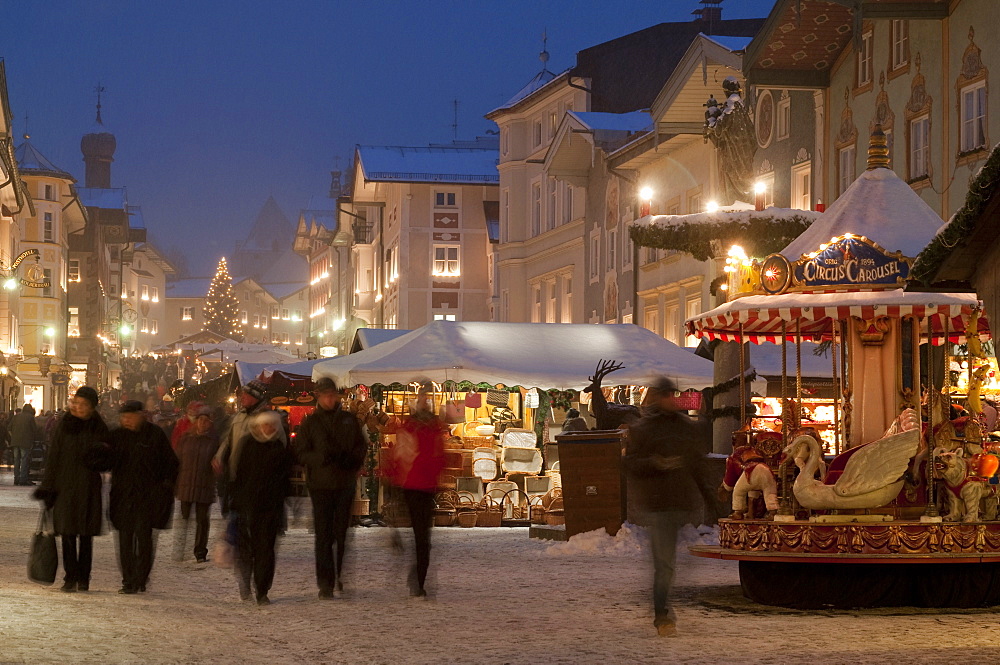 Christmas Market stalls and people at Marktstrasse at twilight, Bad Tolz spa town, Bavaria, Germany, Europe