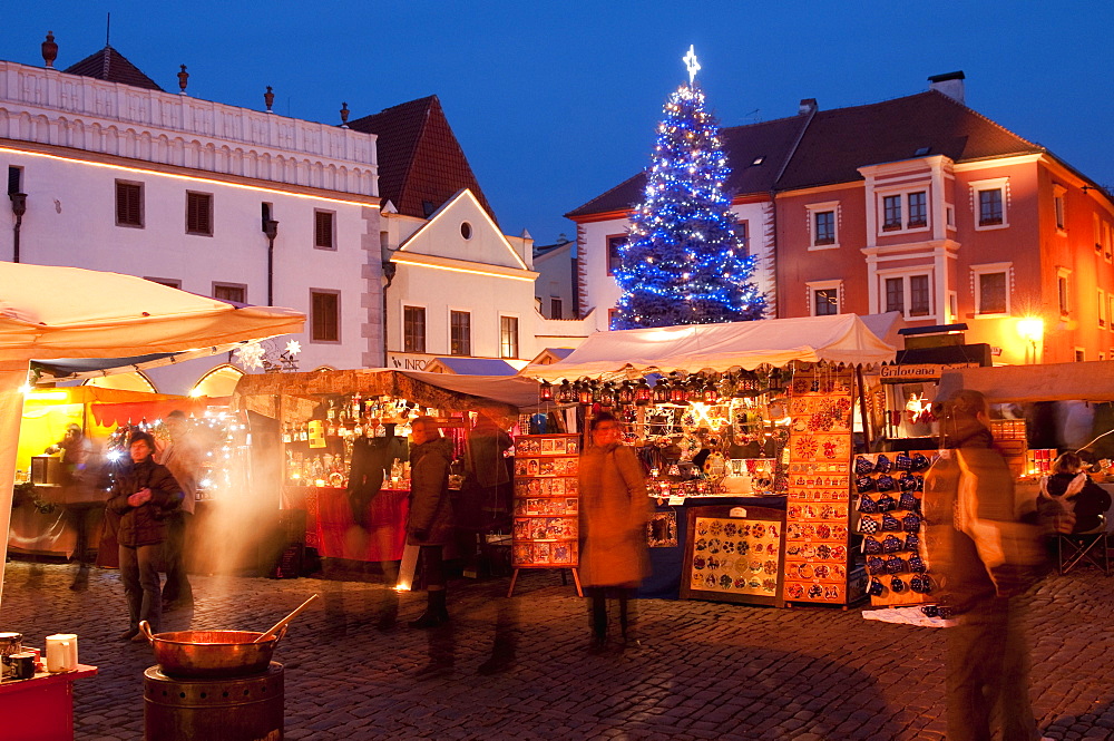 Christmas Market stalls and Christmas tree at twilight, Svornosti Square, Cesky Krumlov, Ceskobudejovicko, Czech Republic, Europe