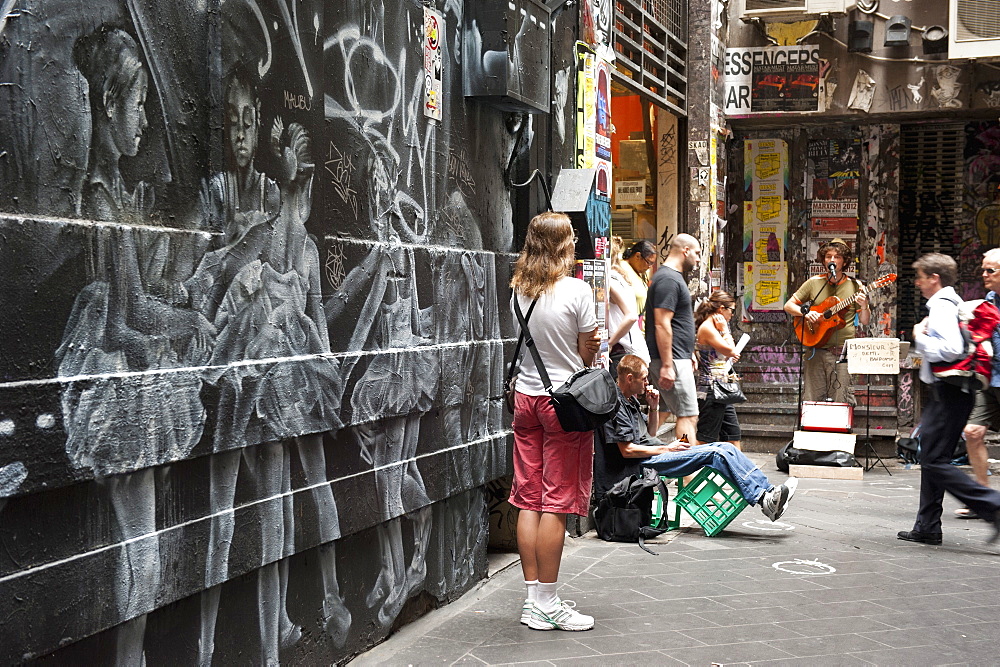 Graffiti and people watching street musician, Central Place, Melbourne, Victoria, Australia, Pacific