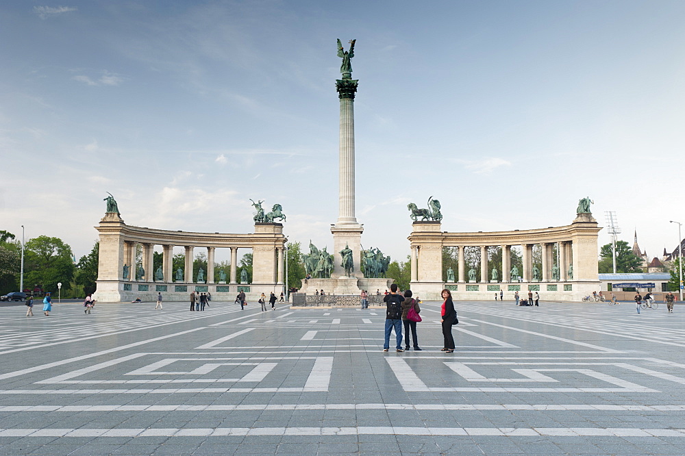 People looking at statues of Hungarian historical leaders, Millennium Monument, Hosok Tere (Heroes Square), Budapest, Hungary, Europe