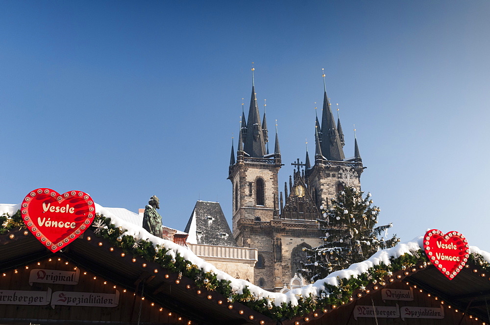 Merry Christmas sign at snow-covered Christmas Market and Tyn Church, Old Town Square, Prague, Czech Republic, Europe