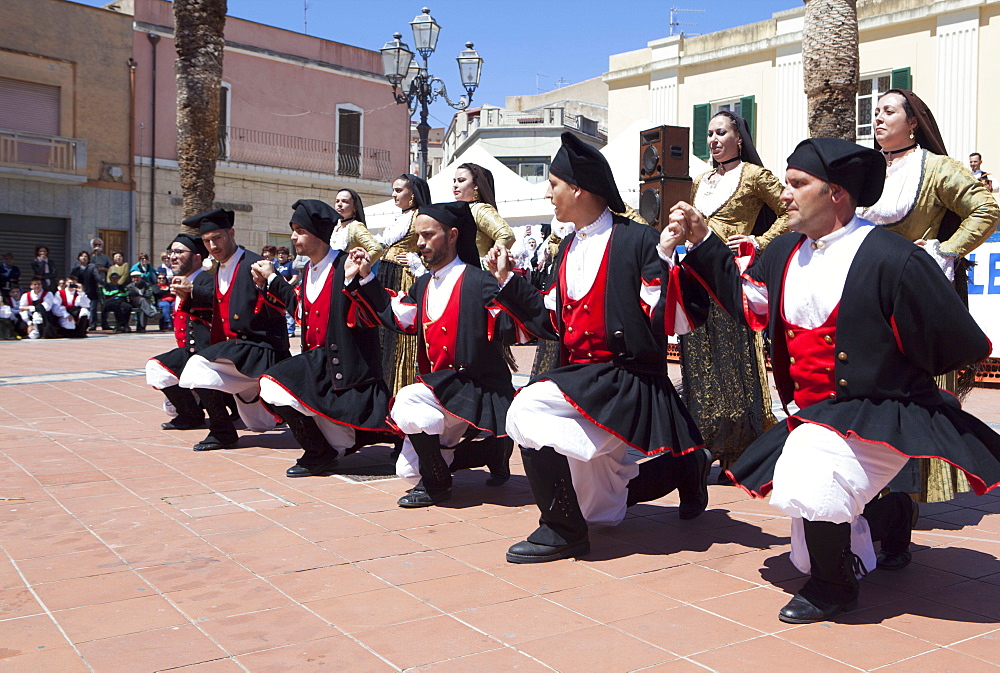 Men kneeling celebrating St. Antioco, patron saint of Sardinia, Sant'Antioco, Sardinia, Italy, Europe