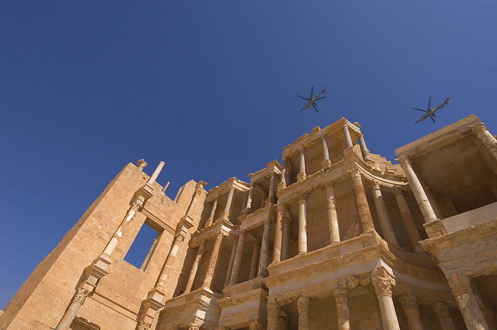 Helicopters flying over Roman Theatre, Sabratha Roman site, UNESCO World Heritage Site, Tripolitania, Libya, North Africa, Africa