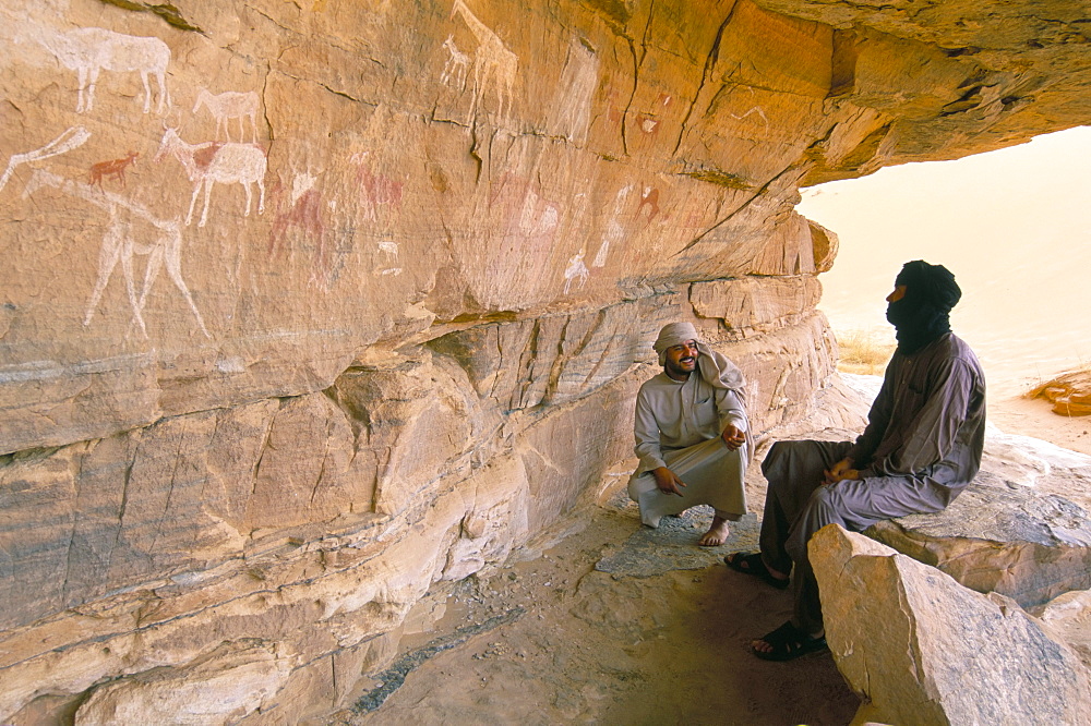 Tuaregs and primitive cave paintings, Akakus, Sahara desert, Fezzan, Libya, North Africa, Africa