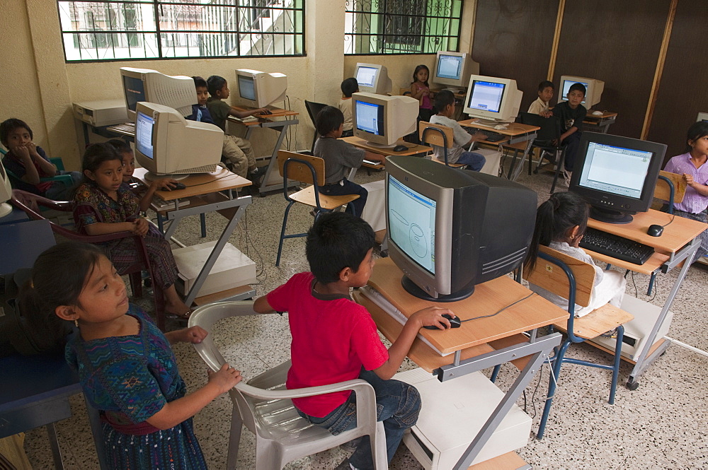 Working on PC at Santa Catarina Palopo primary school, Lake Atitlan, Guatemala, Central America