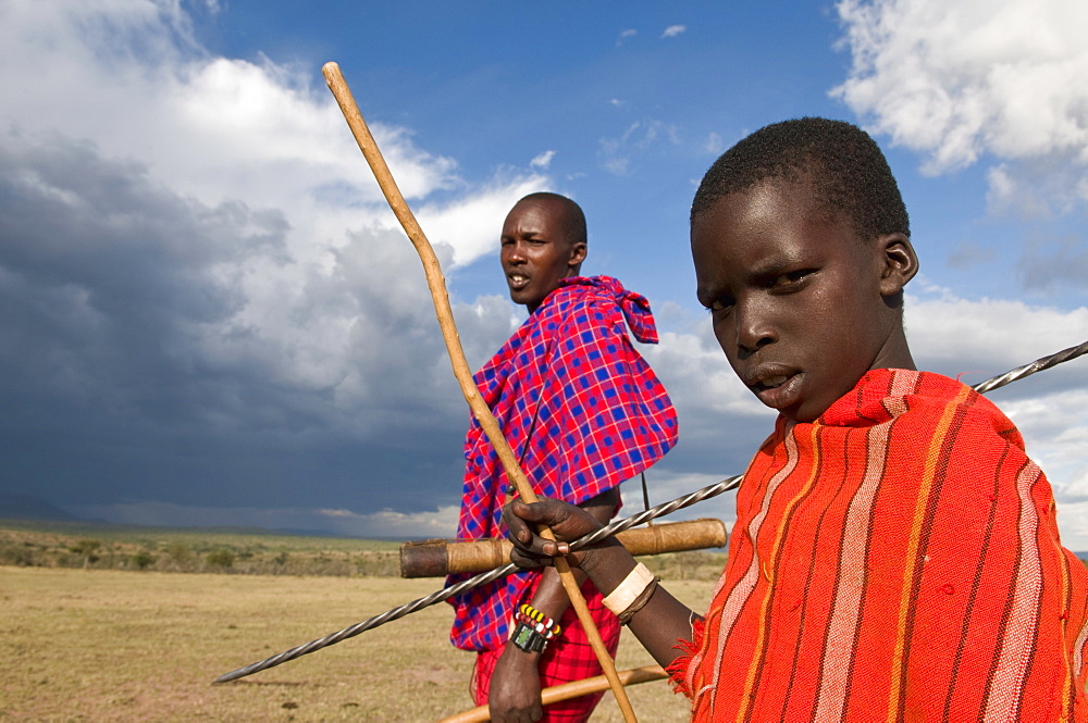 Masai boy with his father, Masai Mara, Kenya, East Africa, Africa