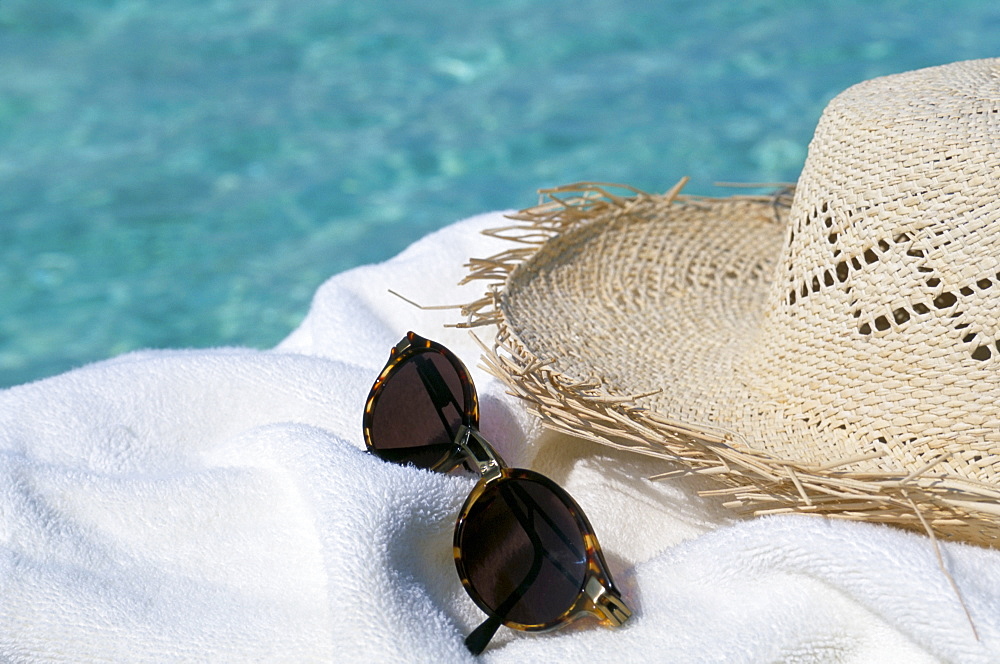 Straw hat and sunglasses on towel, North Male Atoll, Maldives, Indian Ocean, Asia